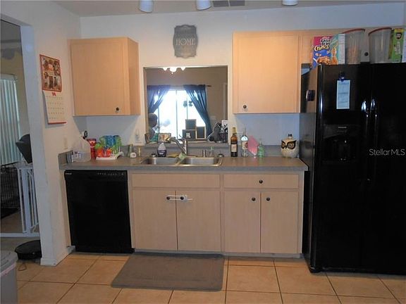 Kitchen with double stainless sink and pass through to the Dinette.