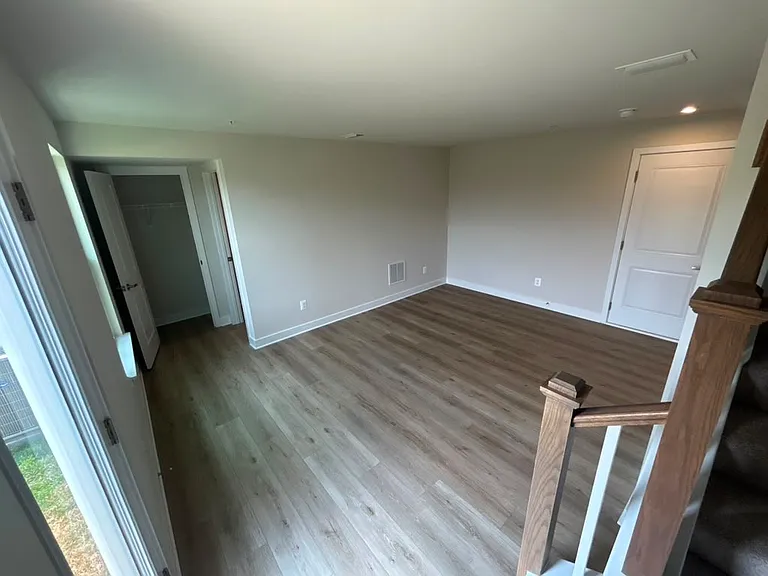First floor rec room with garage entry door on the right and walk out patio door on the left