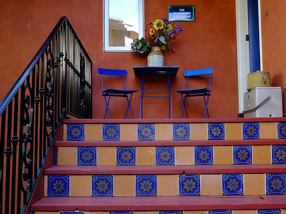 Wrought iron railing upon entrance to home. French tile kick plates on tiles and a french bistro arrangement to rest articles upon entering. Entry key in lock box on door.