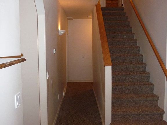 Hallway back to the main level bedrooms and stairs to 2nd floor.