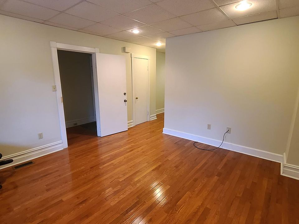 Large living room with hardwood flooring throughout and central A/C and efficient gas heat.