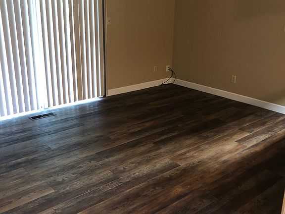 Living area with sliding doors to an outdoor deck suitable for grilling or a small garden
