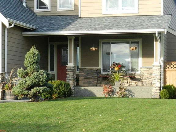 The front porch offers a serene seating nook in the summer and a refuge for visitors from the wind and rain.