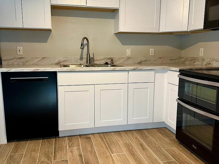 Fully renovated kitchen new cabinets and counter tops. Upgraded appliances include dishwasher, garbage disposal, Electric Double oven/range, over the range microwave, side by side refrigerator/freezer with water dispenser and ice maker.