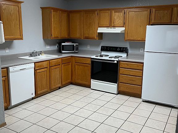 eat-in kitchen with oven, dishwasher, microwave & new fridge