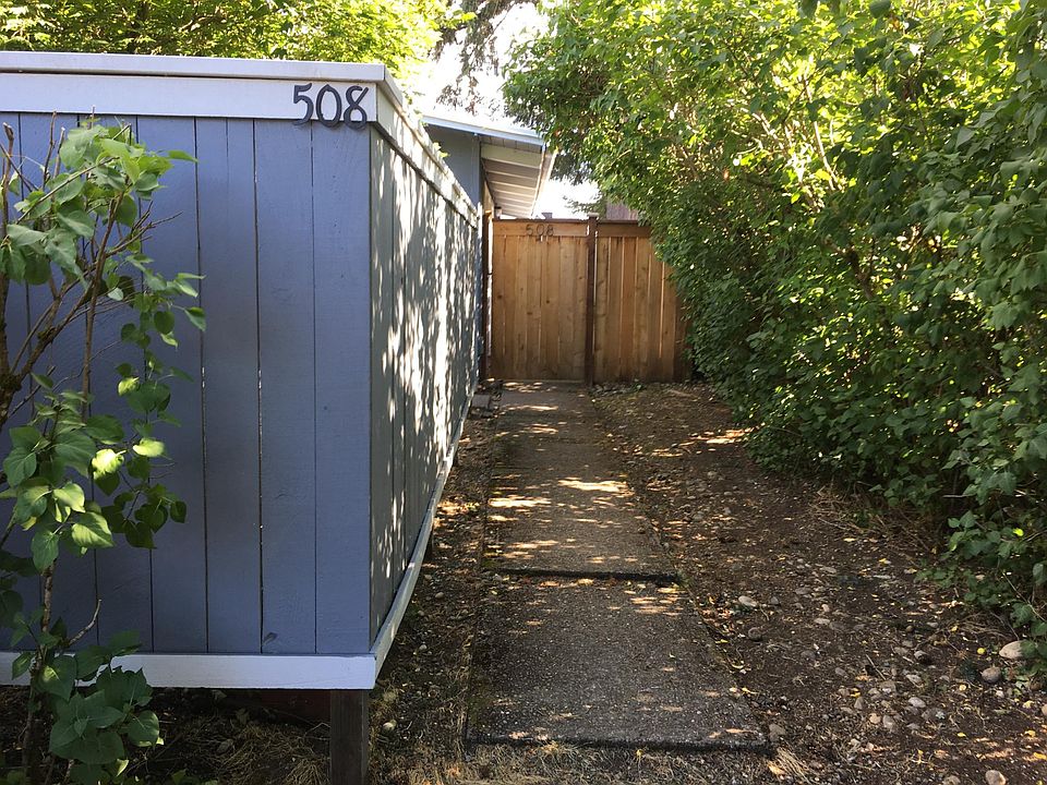 Entrance to 508. Privacy fenced patio on left. Walkway to Private entrance, front door & backyard.