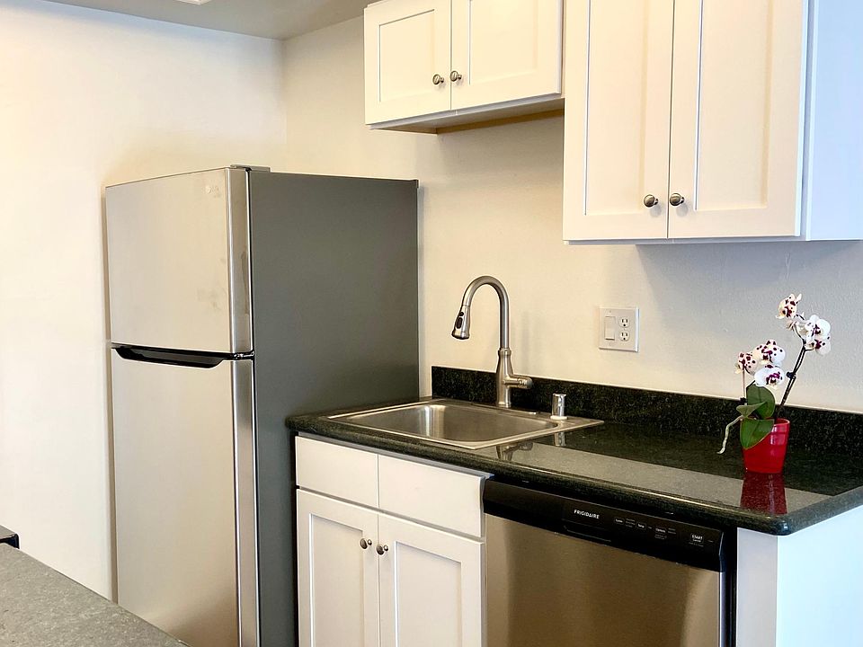 Modern and new. New refrigerator, dishwasher, sink, faucet, granite countertops, cabinetry, and floors.