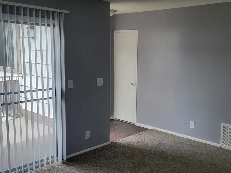 Front enterance living room and hallway to bedrooms and bathroom at Grand Oaks Apartments in Lake Elsinore, California.