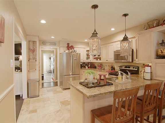 The well appointed kitchen has beautiful built ins, cabinets, granite and light fixtures. The perfect place to cook a great meal!