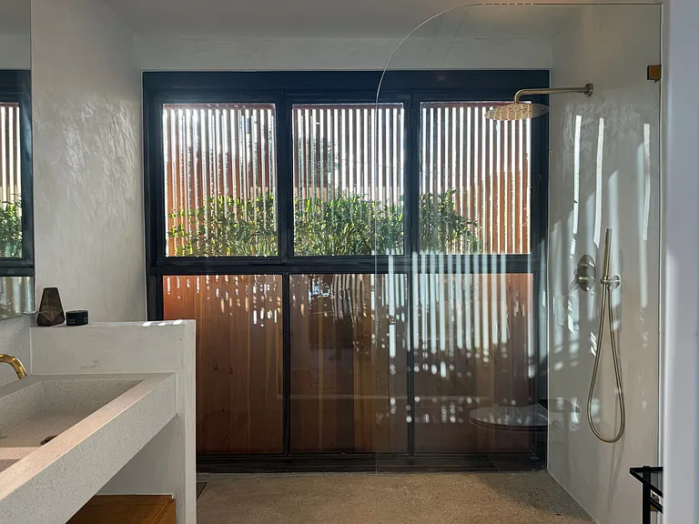2nd floor bathroom windows completely accordion open for the feeling on an outdoor shower from the privacy of your home.