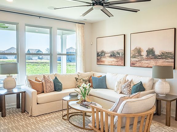 Cozy Gathering Room with Sectional Sofa, coffee table, and ceiling fan