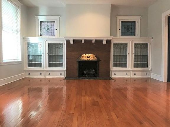 Living room with gas log burning fireplace offers a cozy ambiance! Check out the stunning cabinetry. Fill each with books or personal treasures. It is a decorator's paradise!