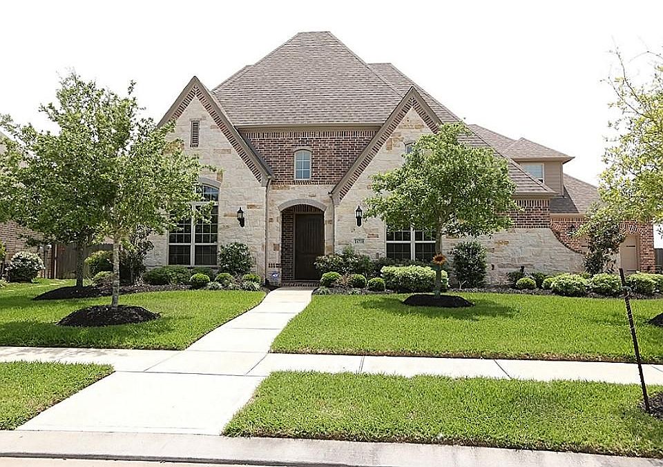 Street view of home with lake view in the back.