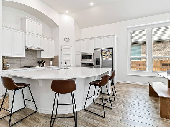 Huge kitchen island with custom backsplash.