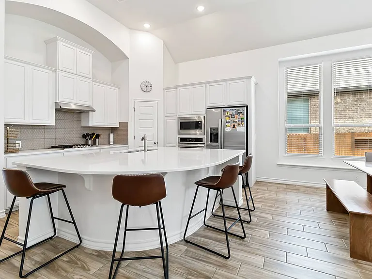 Huge kitchen island with custom backsplash.