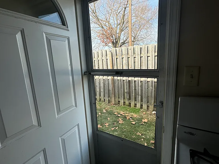 Back door off the kitchen that's leads to the backyard!