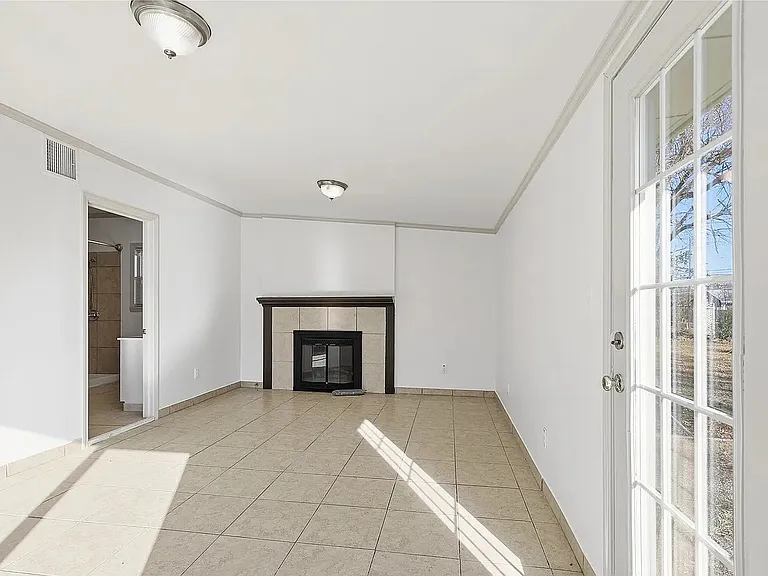 Large flex space featuring a fireplace and private bathroom, ideal for a home office, guest suite, game room, fitness area, or second living space.