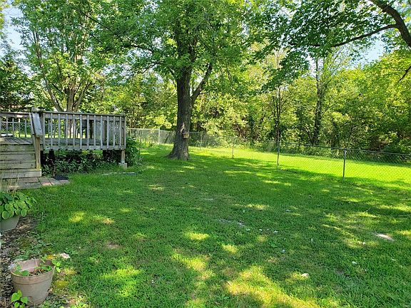 Nice level backyard, partially fenced. Property extends past the backyard tree line