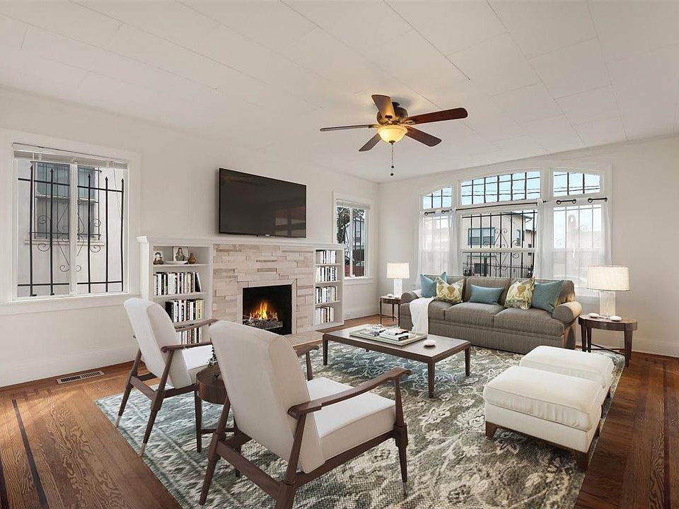 Large windows illuminate the space with the original floors of ornate in-lay wood. 

(Furniture added digitally)