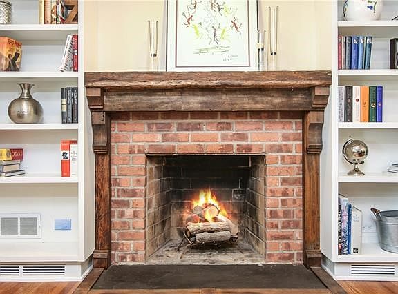 The custom wood fireplace mantel from Soho creates a warm and cozy feeling, perfect for entertaining friends and family.