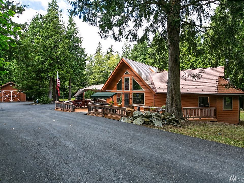 Welcome to 5411 Wood Crest. This immaculate home is set on a secluded 5 acres at the end of a private road in Bellingham. The gorgeous metal roof has a transferable 50 year warranty. There is a barn, RV garage, shop with 2 car garage and 2 large carports. And yes that is an asphalt driveway and parking area in front of all the buildings!