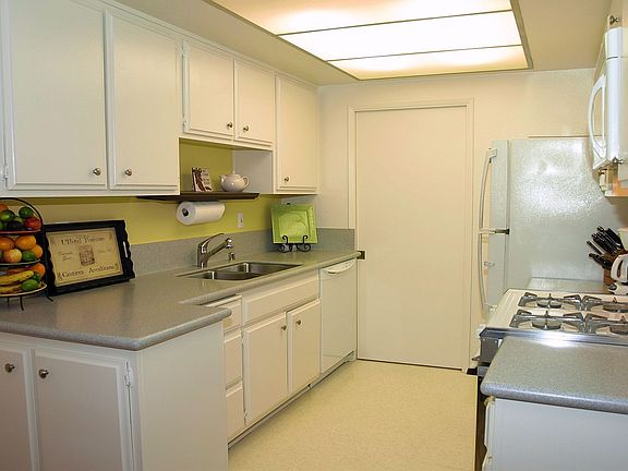 Kitchen has cupgraded countertops and leads to laundry room and pantry.
