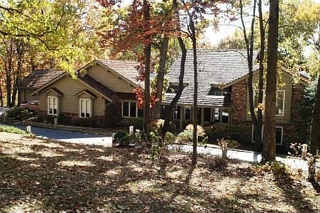 Warm and Inviting entrance with circle drive and custom lighting