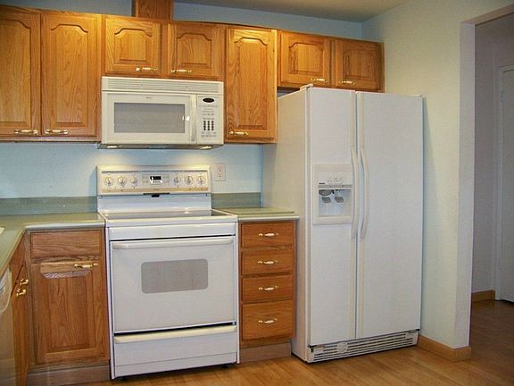 The living room has a fireplace and there are laminate wood floors throughout the entire home.