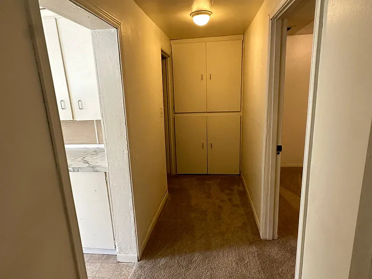 Hallway, leading to two bedrooms and one bathroom