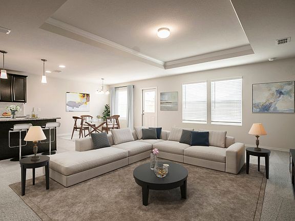 Spacious gathering room with view of kitchen and dining area