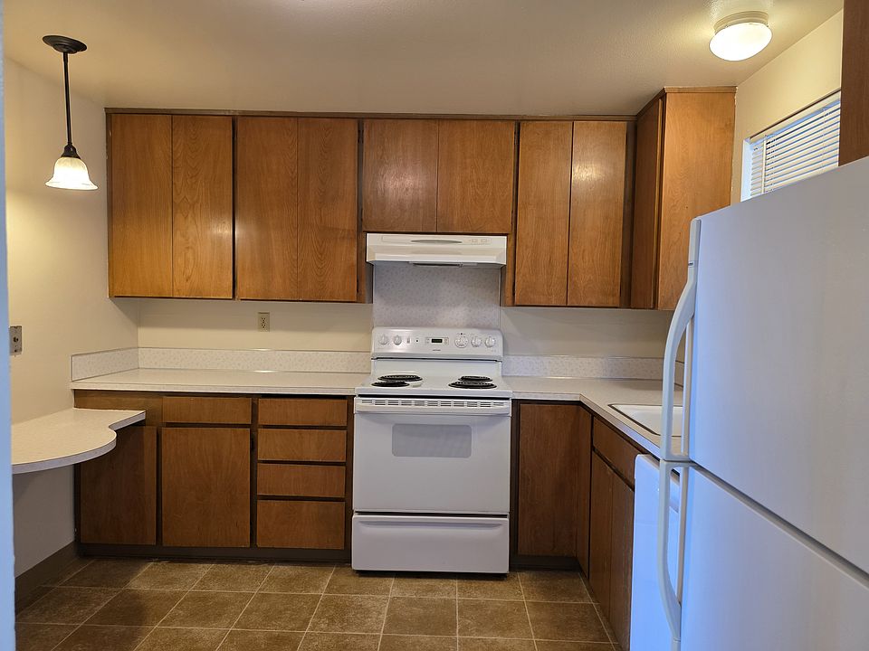 Cook up your favorites in a functional kitchen with warm wood cabinetry and plenty of counter space.