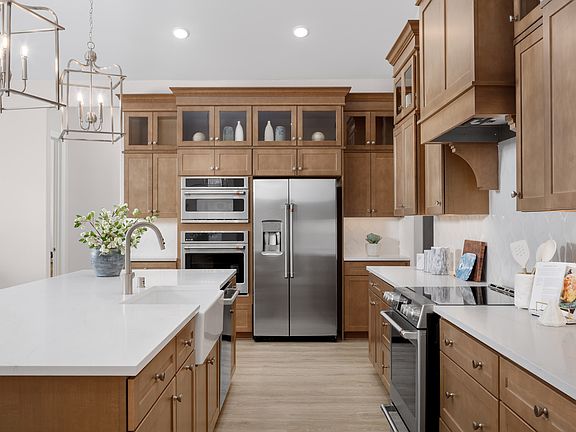 Stainless steel appliances and white apron-front sink