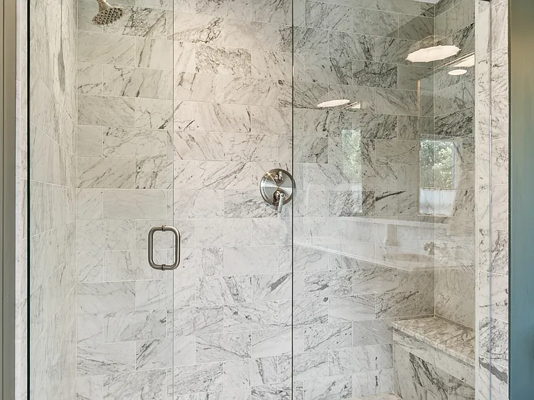 Beautiful primary bathroom attached to bedroom #1. Enjoy a spacious double vanity, huge standing shower, and lots of natural light.