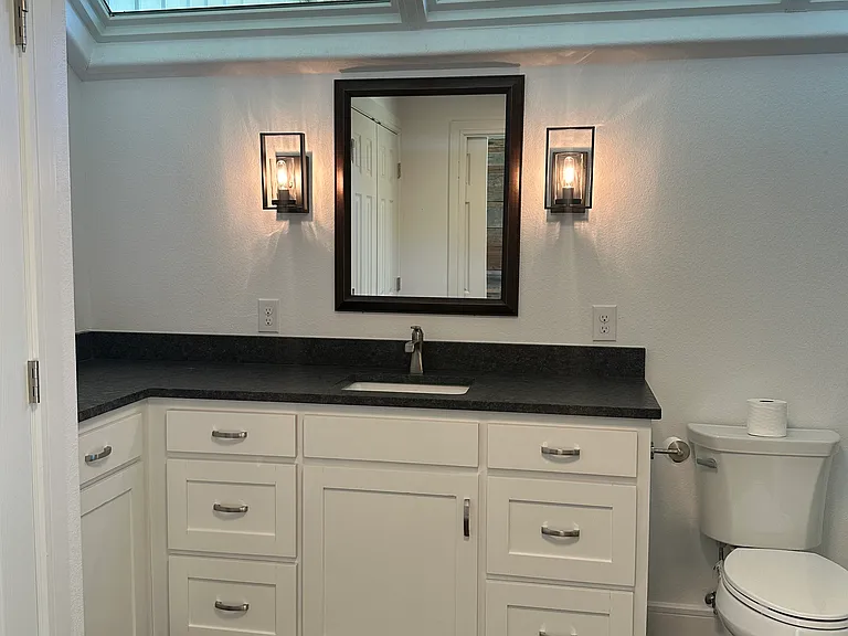 Washer and dryer in skylighted bathroom