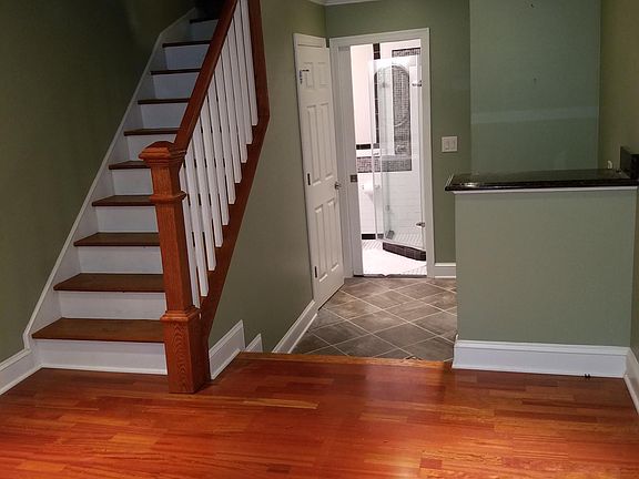 Downstairs room #1 with cherry hardwood and recessed lighting