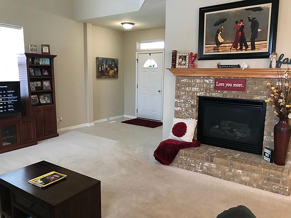 Living room Fireplace w/wood mantle and gas logs. Turns on with a switch.