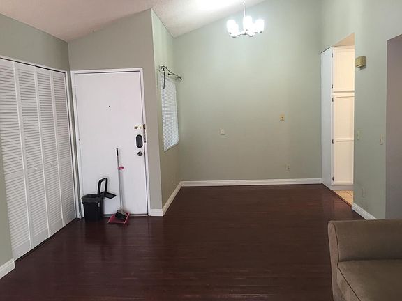 Entry door with laundry to the left and dining area and kit