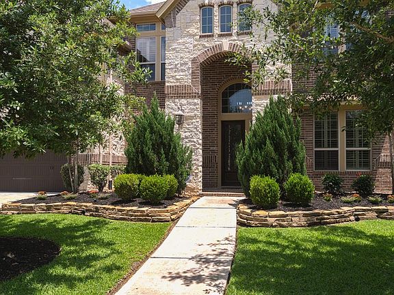 A gorgeous stone and brick elevation greets your guests upon arrival and beckons them to enter the home!