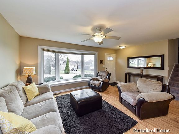 Open living room with bright bay windows