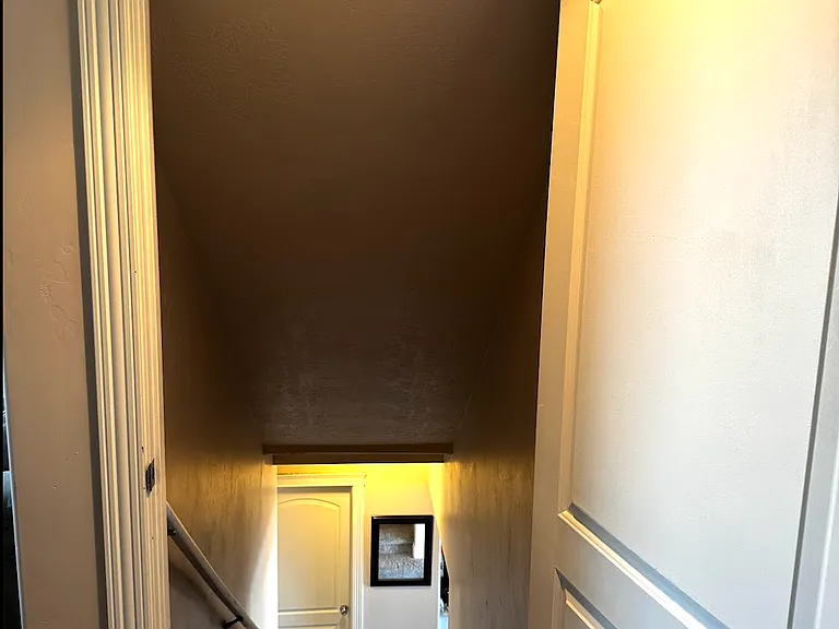 Interior entrance from the garage, through the galley laundry room, down the stairs.