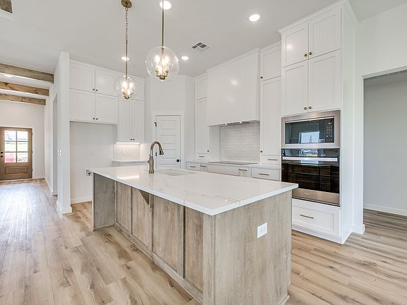 Beautifully bright kitchen with white cabinets from counter to ceiling