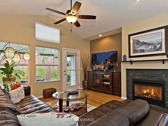 Stone faced gas fireplace in great room.