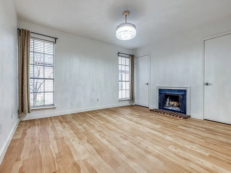 Primary bedroom with a cozy fireplace and 2-closets with ensuite bathroom