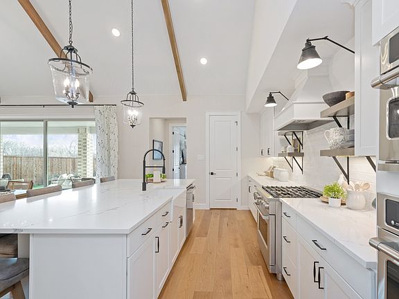 Kitchen with stainless steel appliances and high ceilings