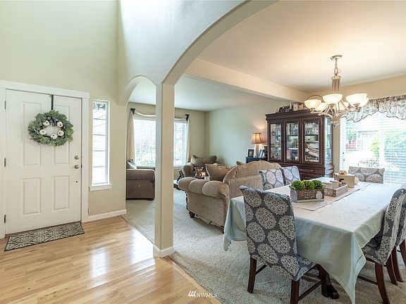 Entryway and formal living room and dining room. Notice all the light streaming in!>