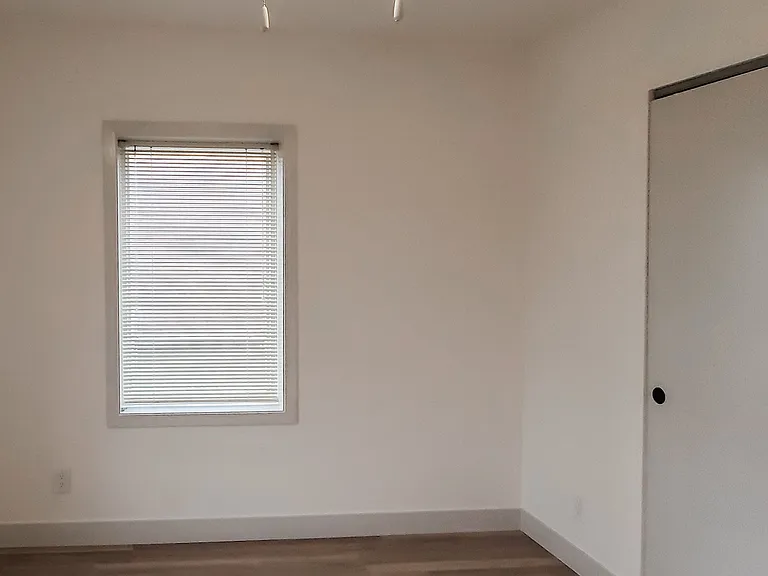 Two windows like this in the larger bedroom