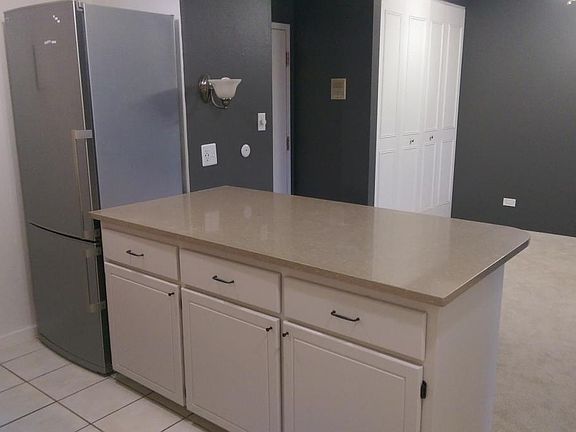 Wide peninsula with room for countertop dining, open to main living area