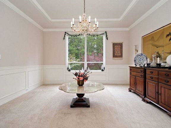 Formal dining room with coffered ceiling and wainscoting.