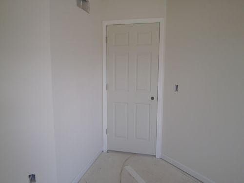6 panel door and white trim throughout