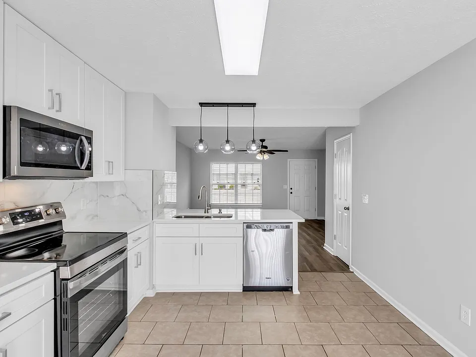 Durable and easy to clean ceramic tile flooring throughout the kitchen and dining area